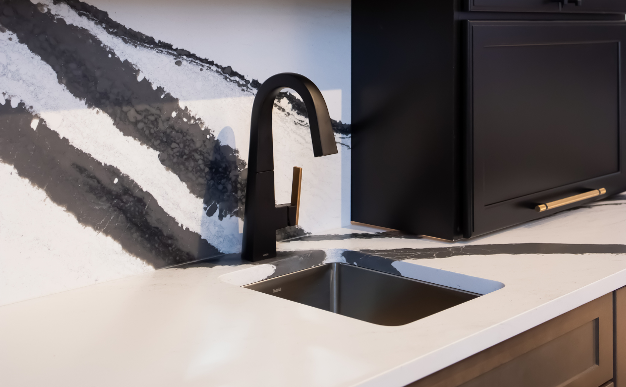 black countertops in a kitchen with terracotta cabinets