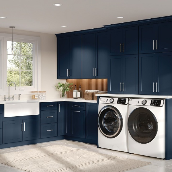 blue custom wooden cabinetry in a laundry room